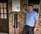 24/7 Emergency Plumbing & HVAC Services 5 Licensed technician inspecting a water heater for quality emergency repairs